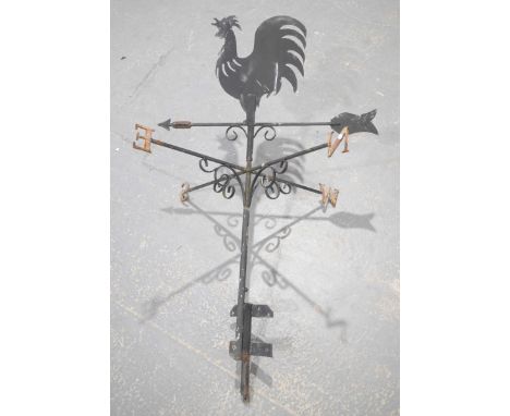 A wrought iron figural weather vaneWith a cockerel silhouette above an arrow pointer and a second swivelling bracket North, E