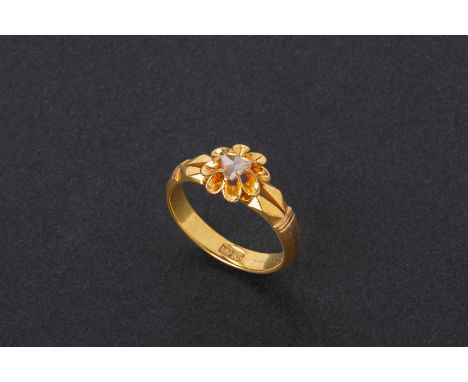 A GOLD AND INTAN RING With a single intan to the centre arranged in a floral design, with stamped Chinese character mark to t