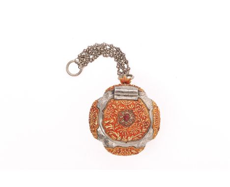 A SILVER AND GOLD COLOURED BETEL NUT BOX The hinged cover set with a synthetic ruby within an intan surround, the panels chas