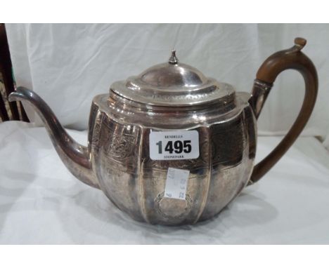 A silver oval ribbed teapot with engraved decoration and wooden handle - lid finial insulator missing