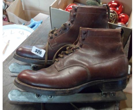 A pair of vintage John Wilson ice skates with brown leather boots