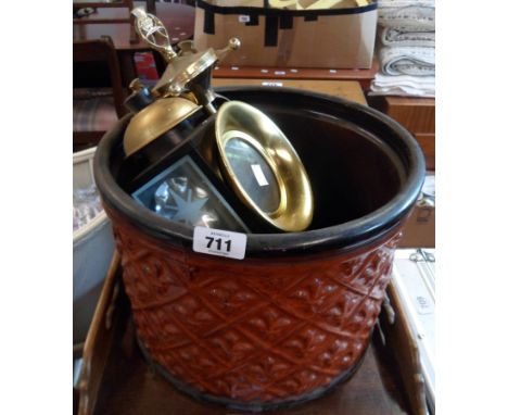 A large ceramic planter containing a modern coach style lamp and a brassed metal companion set