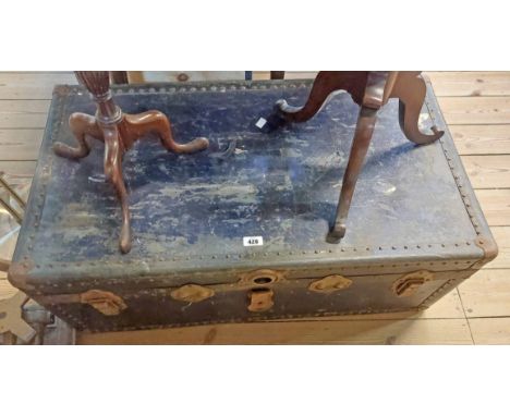 A 90cm old travelling trunk with iron mounts and leather strap handles