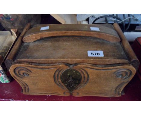 A vintage French wooden box with brass bound handle, locking drawer front and carved and moulded decoration
