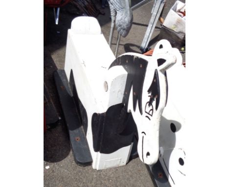 A vintage wooden child's fairground ride seat in the form of a black and white painted horse