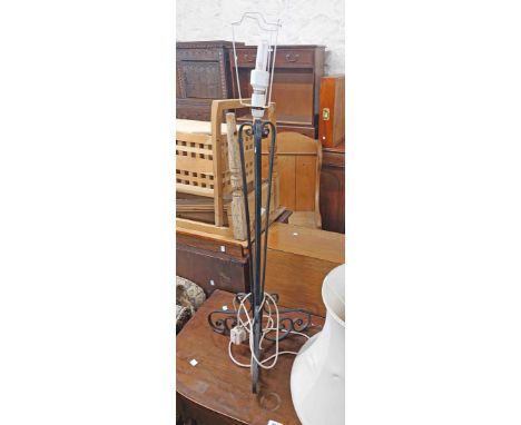 A short painted wrought iron standard lamp with shade, set on scrolling trefoil base