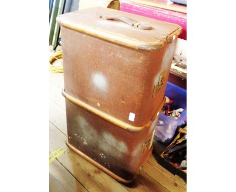 A vintage cane and brass bound travelling trunk with flanking leather strap handles