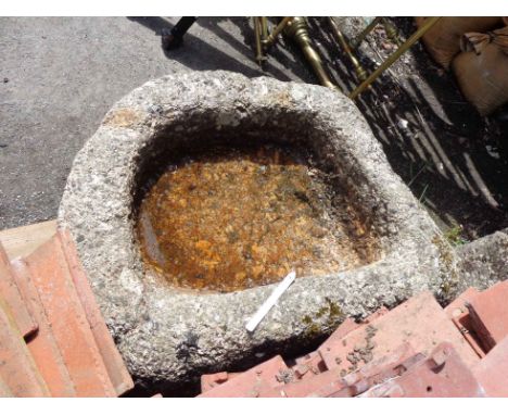 A small old granite trough of elliptical form