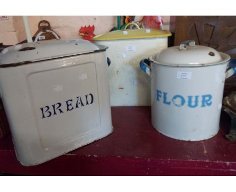 An old enamel BREAD bin with blue stencilled lettering and a yellow lidded example with yellow lettering - sold with a simila