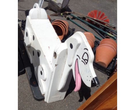 A vintage wooden child's fairground ride seat in the form of a dalmatian dog with painted details