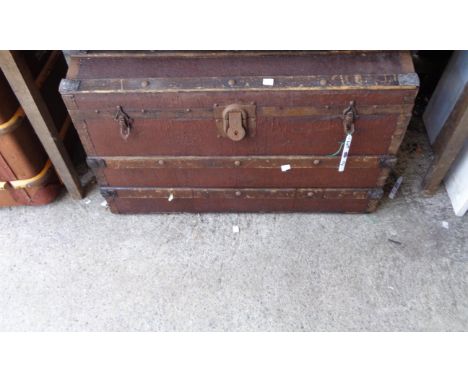 An old dome topped metal bound trunk
