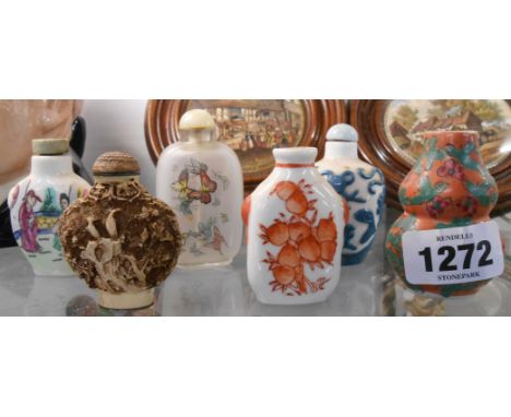 Four Chinese ceramic snuff bottles including hand painted, transfer printed and moulded designs - sold with a reverse painted