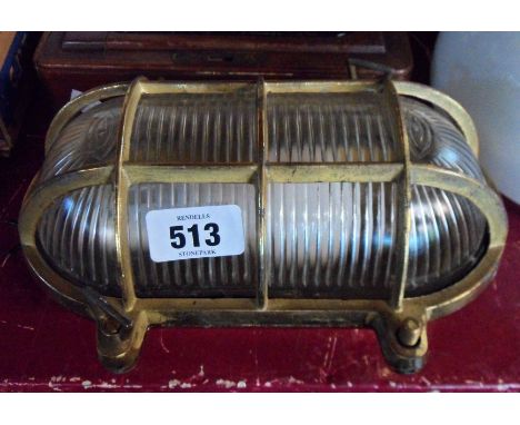 A 20th Century brass bulkhead light with moulded glass shade
