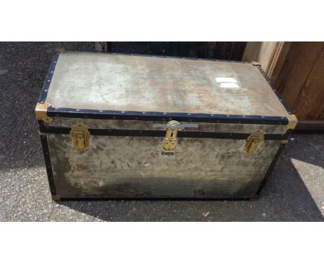 A vintage Mosman tin covered travelling trunk with brass fittings