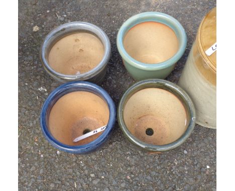 Four small ceramic garden pots with decorative glaze effects