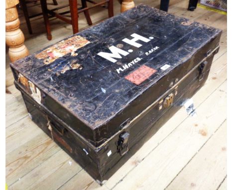 A vintage black travelling trunk with remains of original japanned finish, top marked for M. Hayes R.A.F