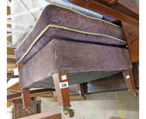 An Early 20th Century Howard &amp; Sons pouffe with later yellow piped purple velour upholstery, set on mahogany tapered legs