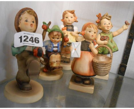 Five Hummel figurines depicting children in various activities