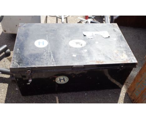 An old black japanned tin trunk with applied shipping labels