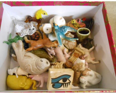 A small box containing a quantity of ceramic and other novelty figurines including Wade Whimsies, glass lampwork, etc.