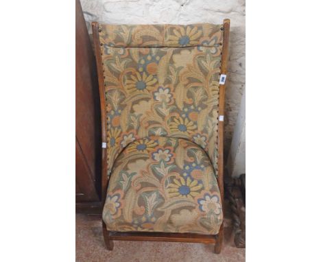 A vintage stained wood framed folding boudoir chair with upholstered back and seat, bearing Atcraft maker's label