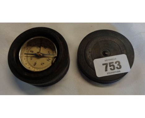 A vintage fob compass contained within a turned ebony box
