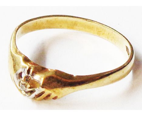 A 9ct. gold ring with setting in the form of a pair of hands holding a diamond chip