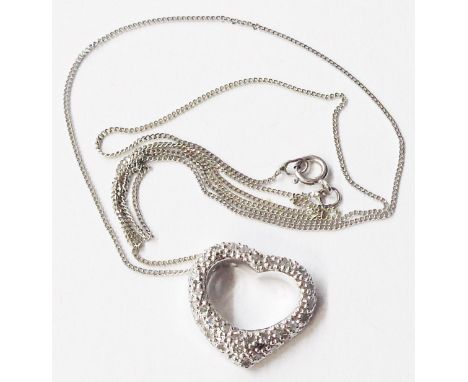 A marked 375 white metal diamond set heart shaped open pendant, on 750 fine link chain
