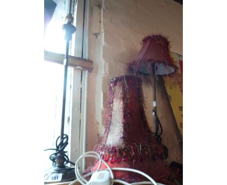 A modern resin table lamp of tall column candlestick form - sold with another similar and three lampshades