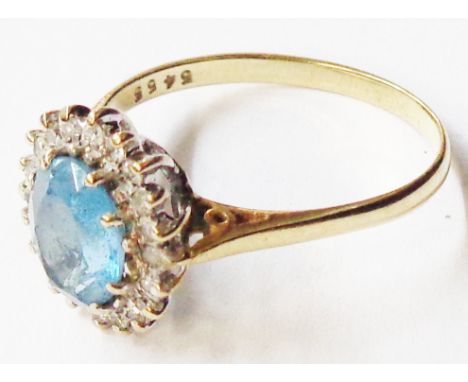 A 9ct. gold ring, set with central oval aquamarine within a diamond cluster border