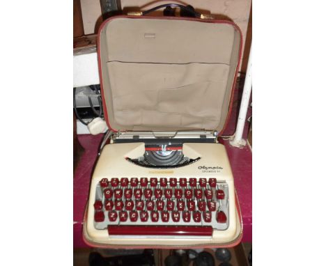 A vintage Olympia Splendid 33 portable typewriter in original case