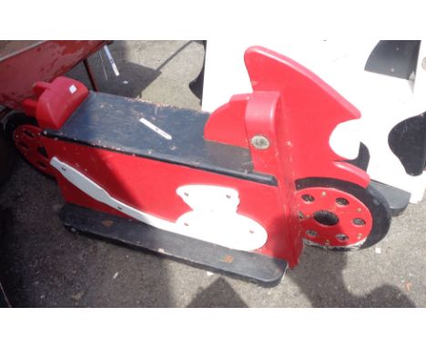 A vintage wooden child's fairground ride seat in the form of a racing motorbike with red and white painted finish