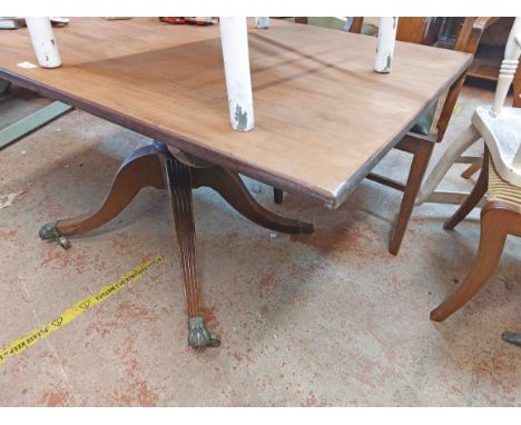 A 1.42m mahogany tilt-top pedestal dining table, set on ring turned pillar and quadruple splayed legs with brass lion paw cap