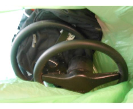 A bag containing Morgan car items comprising two steering wheels and two backpacks