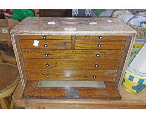 A 42cm vintage mixed wood engineer's cabinet chest with four short drawers over three long graduated internal drawers enclose