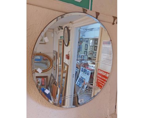 A 60.5cm diameter vintage frameless wall mirror with back etched Viking longboat decoration