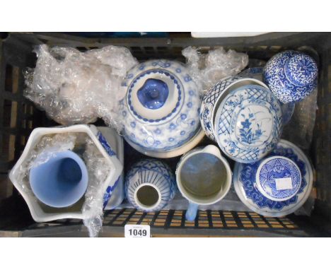 A crate containing a quantity of assorted ceramic items comprising modern Chinese blue and white china lidded boxes, jars, et