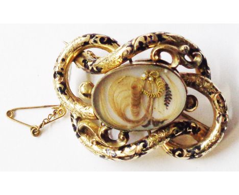 A Victorian hair panel mourning brooch dated 1855 with yellow metal engraved and enamelled open scroll border - some wear to 