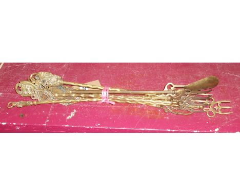 A quantity of brass toasting forks with various finials including Charles Dickens, George V Silver Jubilee with enamel badge,