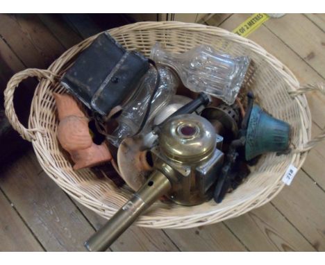 A basket containing a quantity of assorted items including brass coach style lamp, copper two handled pan, beetle form boot j