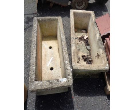 A pair of concrete garden planters of trough form with all over classical knot frieze decoration