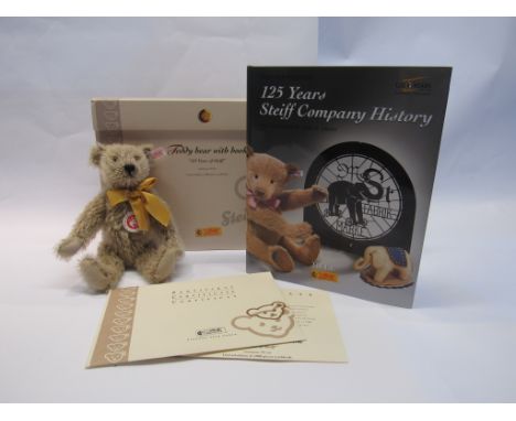 A boxed Steiff limited edition "125 Years Of Steiff" Teddy Bear With Book, jointed cinnamon mohair bear with white tag and bu