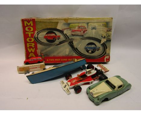 A tinplate boat, Chinese tinplate saloon car, Corgi Formula One Car  and Marx Motorway set (missing one car) 