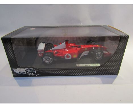 A boxed Hot Wheels Racing 1:18 scale diecast Michael Schumacher F2002 Ferrari Formula One car 