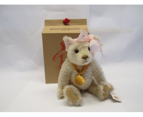 A boxed Steiff 654701 'The Millennium Bear' jointed mohair bear with yellow tag and button to ear, 30cm tall