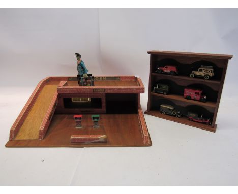 Six Lledo promotional diecast vans on wooden display shelf, a wooden garage and clockwork tinplate toy