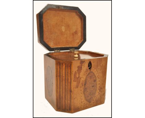 An 18th century Georgian walnut tea caddy having yew wood oval panels and box wood inlays. The cady of octagonal form with hi