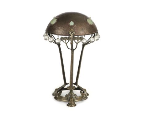 * Table Lamp. A Continental art nouveau table lamp c.1890, the domed copper shade with a hammered finish and inset with opale