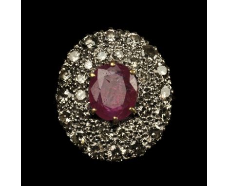 * Ring. An 18ct gold &amp; platinum diamond and ruby ring, the large facet cut ruby surrounded by 30 brilliant-cut diamonds p