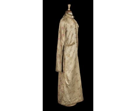 * Indian. A silk tunic, late 19th/early 20th century, yellow silk long tunic, with printed floral pattern, edged with brocade